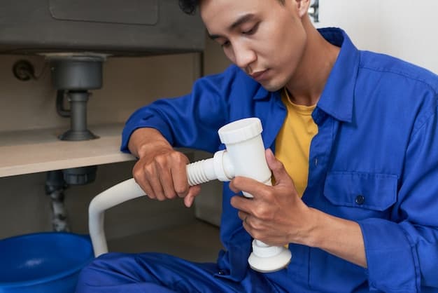 Technician assembling pump pipework during installation